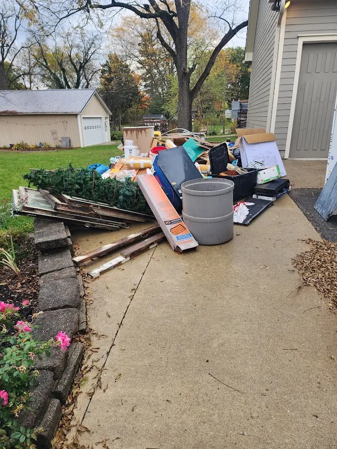Dumpster being loaded with debris for Estate Cleanout Dumpster Rental in Lake Cassidy